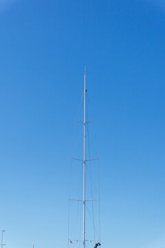 Sailboat mast and rigging reaching blue sky