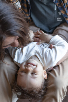 A close-up of a baby being tickled by his parents. Happy baby concept