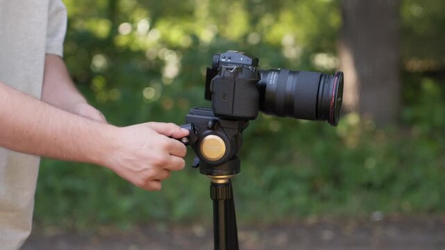 The photographer sets up the tripod