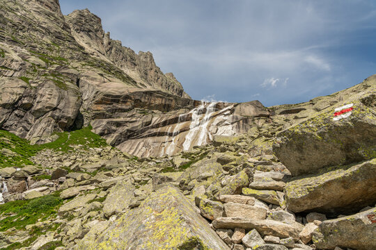 Guttannen, Switzerland. Alpine waterfall cascading over polished granite slabs near Gelmersee hiking trail in the Bernese Alps