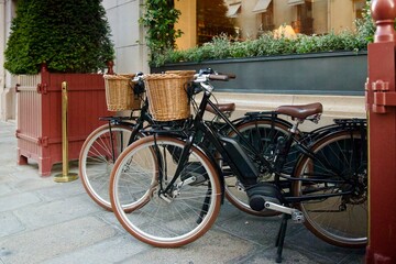 Fototapeta premium pair of matching bicycles on the sidewalk