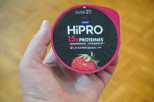 hipro yogurt cup held in hand, danone product with strawberry flavor