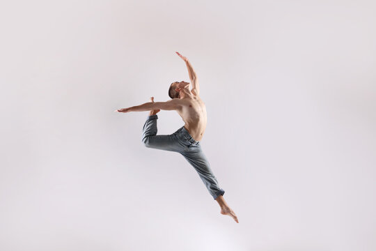 Professional dancer practicing moves on white background