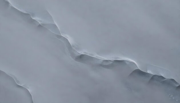 Abstract close-up of a textured gray surface with subtle undulations and shadows