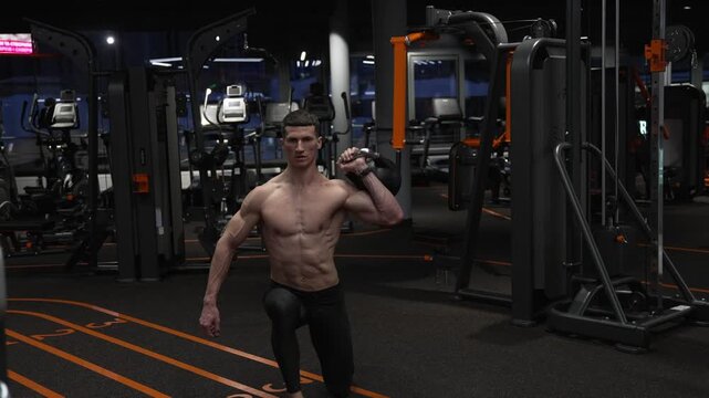 Strength and fitness training. Gym workout exercise, motivation. Sport determination. Sportsman do lunge with kettlebell. Trainer do kettlebell lunge for strength at gym, slow motion