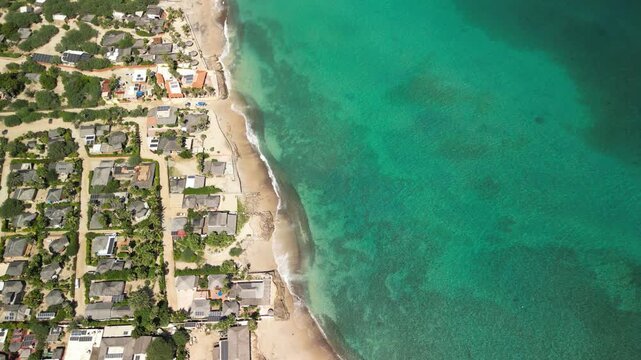 Breathtaking aerial drone shot of the famous Cabo Pulmo village situated on a stunning coastline with incredibly vibrant, crystal-clear azure waters, Sea of Cortez, Baja California Sur
