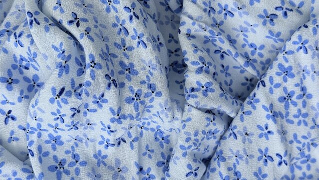 Blue ditsy floral fabric with charming delicate botanical pattern