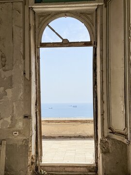 Historic doorway framing peaceful sea view through ancient architecture