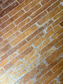 Historic brick floor texture with aged diagonal masonry pattern