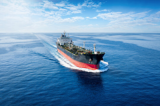 ront view of a chemical goods or oil tanker cruising with speed over calm ocean