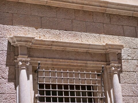 Historic Window with Iron Security Grille and Carved Stone Frame
