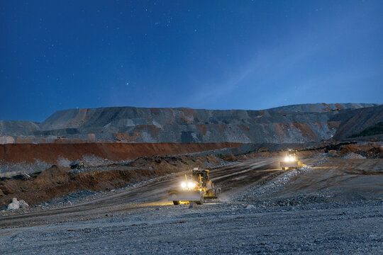 Heavy machinery operating at night in open pit mine