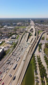 Complex freeway interchange in Uptown Houston, Texas with elevated roads, bridges and city infrastructure defining modern American metropolis.