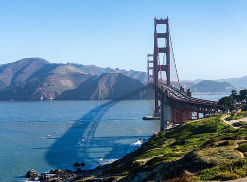 The landmark Golden Gate Bridge spans the entrance to the Pacific Ocean near the coastal hills of Marin County California.