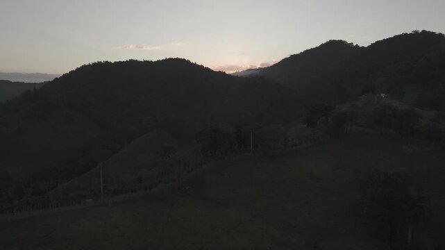 Aerial drone flying toward sunrise over Guag&uuml;&iacute; Mountain, La Vega, Dominican Republic