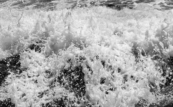 Frozen motion Pacific Ocean surf crashes against the rugged volcanic rock formations at Rodeo Beach within the scenic Marin Headlands of California.