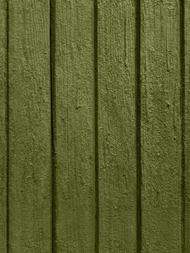 Old painted wooden door texture in olive green with grooved panels weathered rustic wood grain detailed vertical background seamless surface pattern backdrop