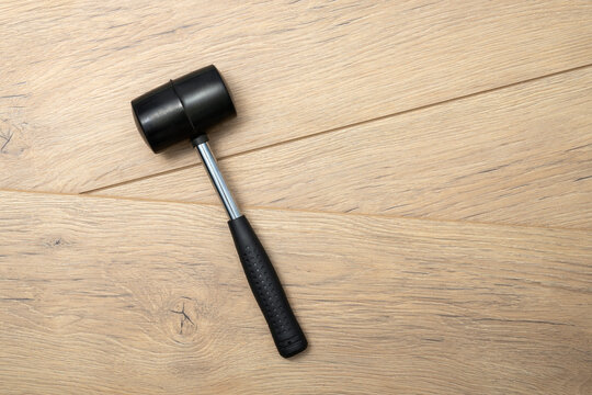 Rubber mallet tool on laminate boards with copy space