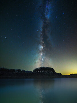 Milky Way  galaxy on the sky over the lake and mountains Space, night scene time lapse.