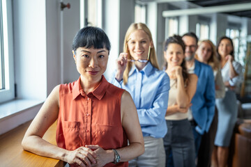 Obraz premium Diverse business team standing together in modern office
