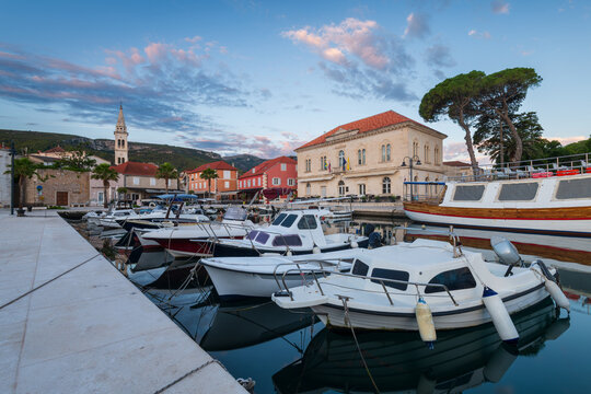 Boats and historic town hall in Jelsa harbor at sunset, Hvar island