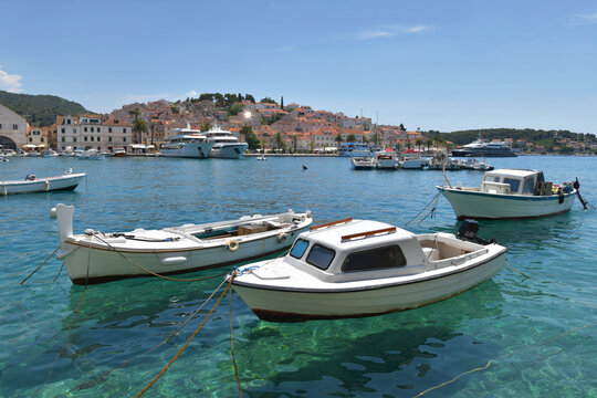 Small boats moored in the clear turquoise water of Hvar town harbor, Croatia