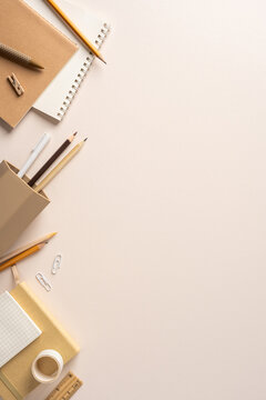 Back to school flat lay with neutral stationery, pencils and notebooks on pale vertical background for study and office