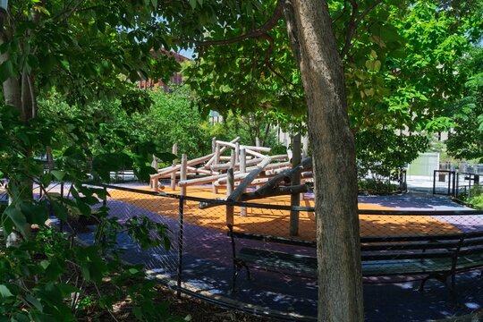 Wooden log climbing structure in urban park playground