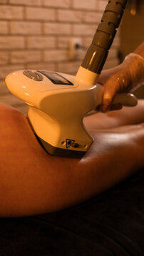 Apparatus massage. Vacuum roller massage. Anti-cellulite foot massage. Dim atmospheric warm light. self-care, care, weight loss
