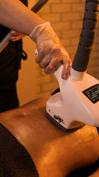 Apparatus massage. Vacuum roller massage. Anti-cellulite abdominal massage. Dim atmospheric warm light. self-care, care, weight loss