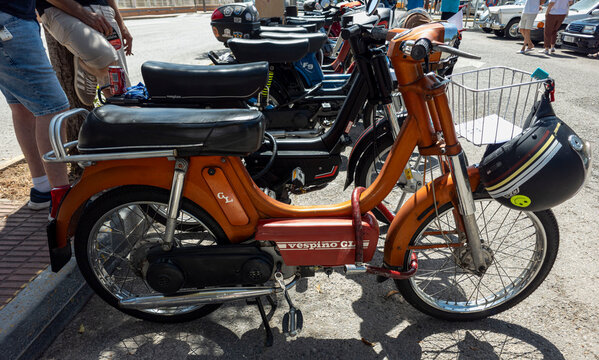 TAVERNES BLANQUES, SPAIN - JUNE 14, 2026.Classic orange Motovespa Vespino GL moped on display at vintage vehicle exhibition in sunny Spain