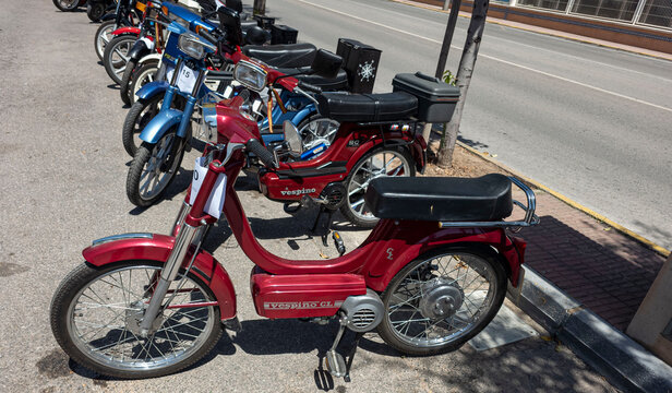 TAVERNES BLANQUES, SPAIN - JUNE 14, 2026.Vintage mopeds parked at a historic motor gathering in Spain featuring a red Motovespa Vespino GL