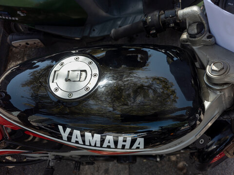 TAVERNES BLANQUES, SPAIN - JUNE 14, 2026.View of a black fuel tank with branding on a vintage Yamaha TZR motorcycle in a parking area