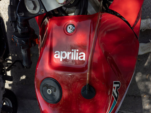 TAVERNES BLANQUES, SPAIN - JUNE 14, 2026.Close up view of glossy red fuel tank with Aprilia logo at classic sport bike show in Spain