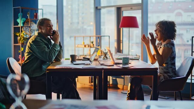 Excited man phone call woman high five celebrating good news. Startup team win