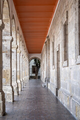 Fototapeta premium Captivating long stone archway corridor within the historic Cabanas Cultural Center in Guadalajara. Detailed old architecture.