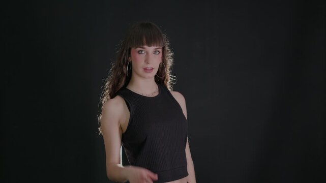 Confident young woman pointing finger at camera