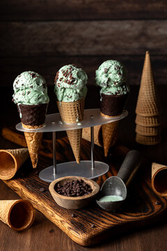Mint chocolate chip ice cream cones against a dark background.