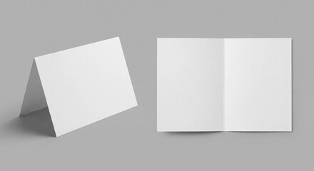 Fototapeta premium Mockup scene with two blank white folded greeting cards on grey background. One standing upright, one open flat.