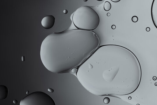Oil and water grey bubbles merging abstract background