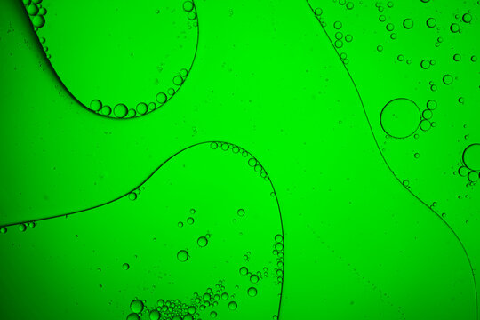 Abstract green oil bubbles floating in liquid texture