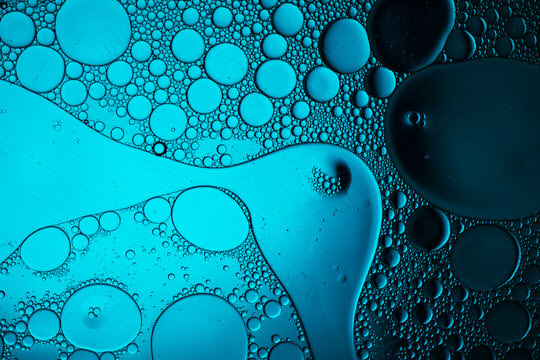 Blue oil and water mixing creating abstract texture