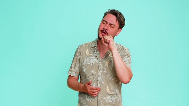 Middle-aged man pretends to sing into imaginary microphone with energetic gestures, enjoying moment of musical performance. Young adult guy isolated on blue background showing fun, passion and emotion