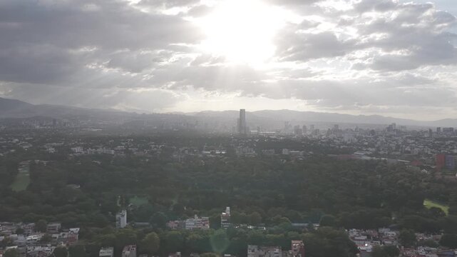 Aerial panoramic view flying sideways over Coyoac&aacute;n at sunset with golf course visible, Mexico City, shot in D-Log M