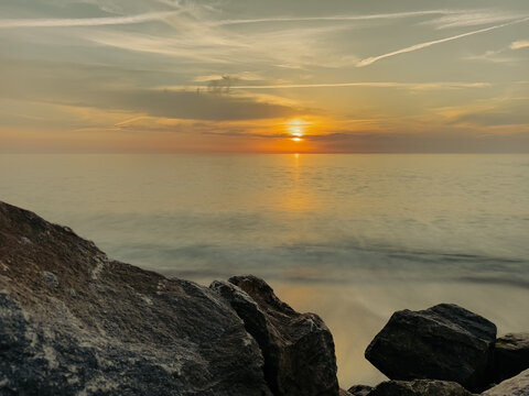 Golden sunset over rocky Furadouro beach Ovar view