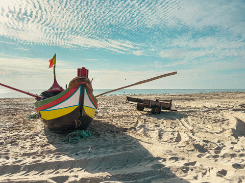 Traditional Portuguese fishing boat on a sandy beach
