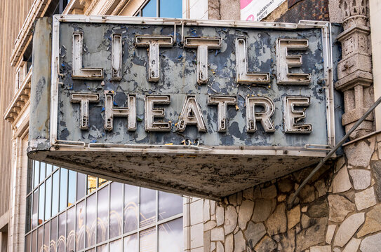 Newark, NJ - US - Jul 26, 2026 The iconic, weathered neon sign for the historic "Little Theatre" marquee hanging over a classic stone-and-glass storefront facade in Newark, New Jersey.