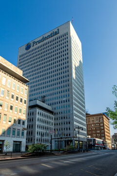 Newark, NJ - US - Jul 26, 2026 Low angle view of Prudential Tower in Newark, New Jersey, rising above downtown streets with modern office facade, flags, and clear blue sky in morning light.