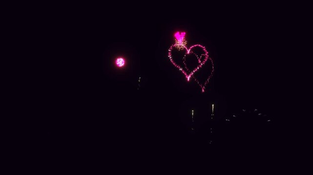 3D Render A captivating night sky with dynamic fireworks display, featuring a heart-shaped pattern of vivid pink and other colors