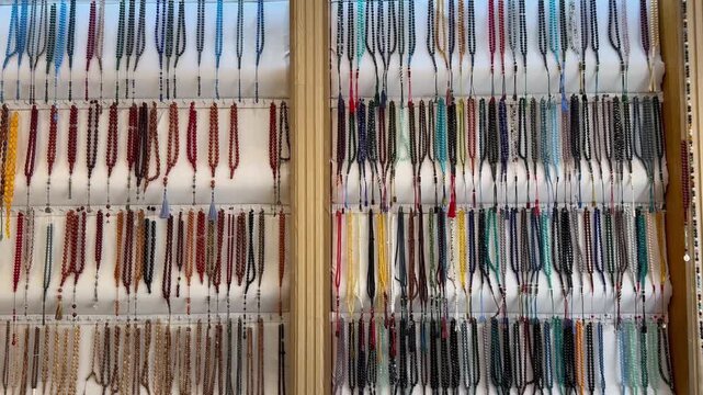 Display wall of traditional colorful Islamic prayer beads and rosaries in a local market